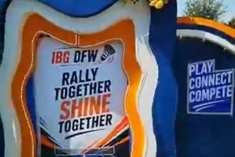 Outdoor IBG DFW backdrop on grass reading Rally Together, Shine Together, beside a Play, Connect, Compete panel