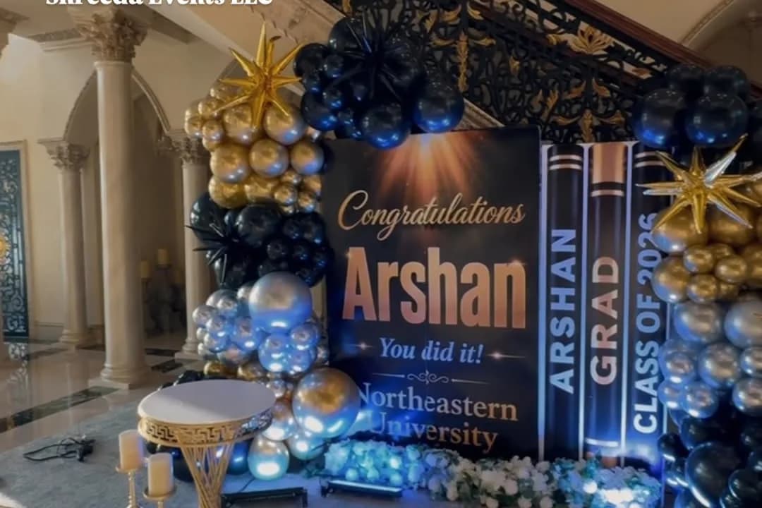 Navy graduation backdrop reading Congratulations Arshan, You did it, with Class of 2026 banners and navy, silver and gold balloons beside a staircase